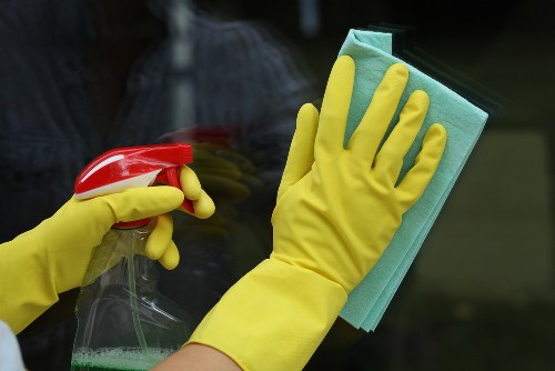 Professional oven cleaner in Nw6 removing grease from a kitchen oven