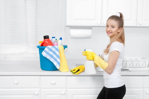 Local cleaner vacuuming a carpet in an NW6 home